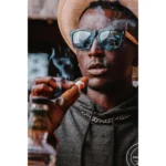 Man holding a lit handmade premium Bongani Robusto cigar